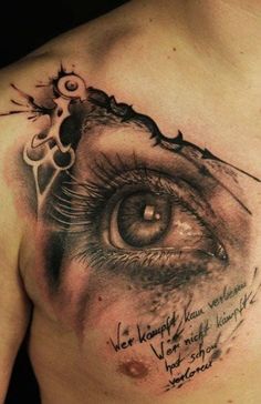 a close up of a person's chest with an eye and words on it