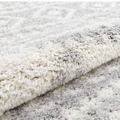 a white and grey rug on the floor