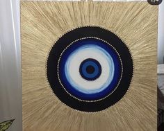 a painting with blue and white circles on it's side in front of a door