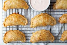 baked pastries on a cooling rack with dipping sauce