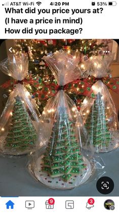 three bags filled with christmas trees sitting on top of a table next to a christmas tree