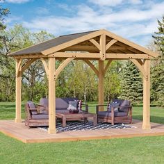 a wooden gazebo sitting on top of a lush green field