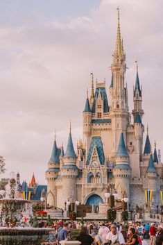 people are standing in front of a castle