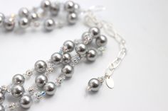 Our Silver Elegance necklace is a stunning accessory that pays tribute to classic elegance with its graceful, cascading strands of pearls, rhinestones and crystals. Featuring gorgeous Swarovski© glass pearls in different hues, a sparkling rhinestone ball and Swarovski© Crystals. Silver chain is adjustable ready to fit any outfit. Make it your own, and wear it in any way that suits you. Elegant Beaded Silver Bridal Necklace, Elegant Double Strand Crystal Necklaces, Elegant Silver Bridal Necklace With Round Beads, Elegant Silver Beaded Necklaces With Round Beads, Luxury Silver Multi-strand Pearl Necklace, Silver Beaded Necklace With Rhinestones For Wedding, Elegant Silver Multi-strand Beaded Necklaces, Elegant Pearl Necklace With Rhinestones For Gift, Elegant Crystal Pearl Necklace For Party