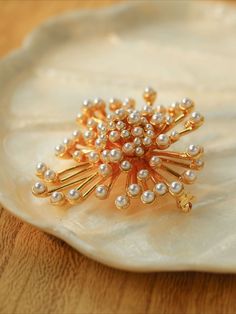 Introducing our Vintage Fashion Pearl Firework Brooches - a charming and stylish accessory, they offer a gorgeous and luxurious look thanks to their unique vintage inspired design. Perfect for both casual and formal attire, these brooches display vintage-inspired fashion and timeless elegance. Metal: 18K Recycled Gold Plated On Brass Gemstone:Imported artificial pearls Dimensions:45*50mm Weight: 26.5g Elegant Brooch Pins For Vintage Events, Elegant Vintage Brooch Pins, Elegant Brooches For Vintage Events, Elegant Gold Brooch Pins, Classic Gold Party Brooch, Elegant Gold Brooches For Party, Elegant Gold Pins, Elegant Gold Wedding Pins, Luxury Brooch Pins For Wedding