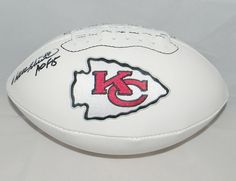 a football with the kansas chiefs logo on it is sitting on a white tablecloth