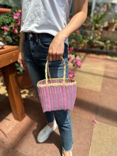 Beautiful recycled plastic small tote bag handwoven by the local artisans of Guatemala. This bag is eco-friendly, water resistant and very light. In small size, fits daily needs.Ideal for children too.Each piece is handmade featuring a unique design.As a unique handmade product each product may vary.No two are exactly the same and imperfections are to be expected and appreciated.MEASUREMENTSLength: 7"Width: 4.5"Height: 6"(approximately)As a handmade product size may vary.MEASUREMENTSRecycled pla Casual Pink Handwoven Straw Bag, Eco-friendly Square Straw Bag For Market, Eco-friendly Square Beach Bag, Eco-friendly Handheld Beach Bag, Handmade Eco-friendly Pink Beach Bag, Pink Handwoven Straw Bag For Everyday Use, Pink Handmade Eco-friendly Beach Bag, Everyday Pink Handwoven Straw Bag, Eco-friendly Pink Straw Bag For Daily Use