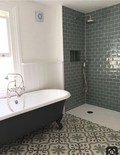 a bath tub sitting next to a shower in a bathroom