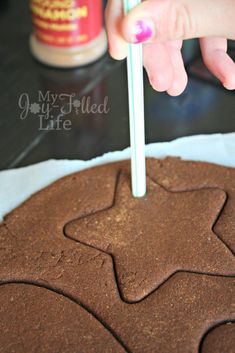 someone is decorating a cookie with chocolate icing