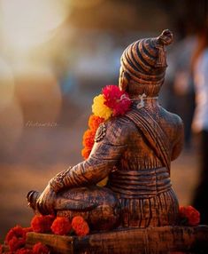 an elephant statue with flowers on its head