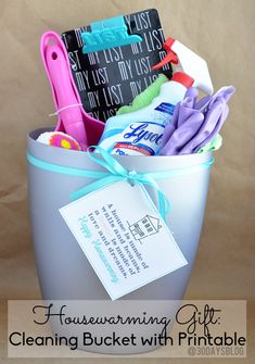 a bucket full of cleaning supplies with a tag attached to the handle that says housewarming gift