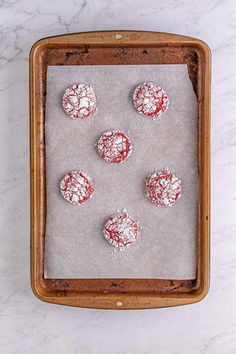 cookies on a baking sheet covered in powdered sugar