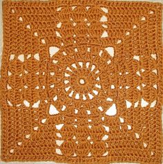 an orange crocheted doily with hearts on it