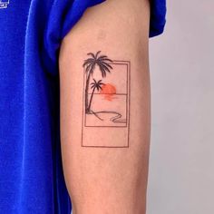 a person with a tattoo on their arm that has a palm tree and sunset in the background