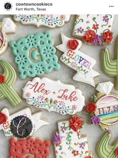 decorated cookies are arranged in the shape of flowers and cactuses, including one that says aloe like