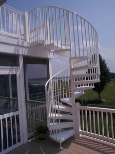 there is a white spiral staircase on the deck