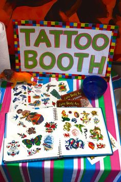 a table topped with lots of tattoos on top of a colorful cloth covered tablecloth