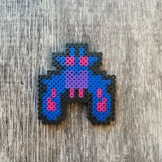 a small pixellated object on top of a wooden table