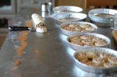 several pie tins are lined up on the counter with one half eaten pastry in it