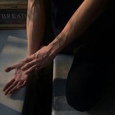 a person with their hands on top of a mattress