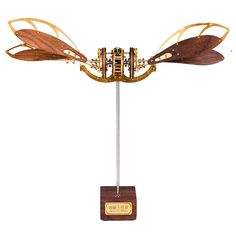 a wooden and metal sculpture with two wings on it