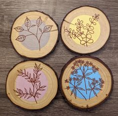 four wood slices with different designs on them