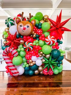 a christmas balloon arrangement in the middle of a room