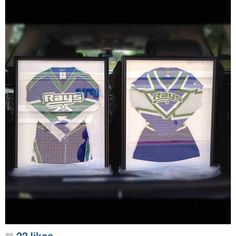 two framed hockey jerseys sitting in the back of a car