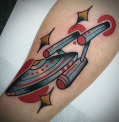 a tattoo on the arm of a man with a spaceship