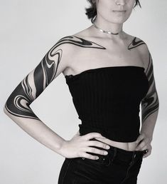 a woman with tattoos on her arms and shoulder