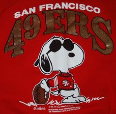 the back of a red shirt with a cartoon dog holding a football