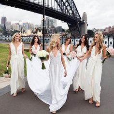 the bridesmaids are walking down the street in their wedding gowns and dresses