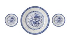 three blue and white plates sitting next to each other