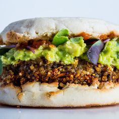 a sandwich with meat, avocado and other toppings