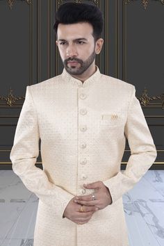 This men's sherwani (traditional Indian attire) features expertly crafted thread and sequin work. The intricate detailing adds a touch of elegance to any occasion. Made from high-quality materials, it offers both style and comfort. Perfect for those seeking a traditional yet sophisticated look. Designer Cream Sherwani With Long Sleeves, Designer Cream Fitted Kurta, Elegant Cream Sherwani With Zari Work, Designer Long Sleeve Cream Sherwani, Designer Cream Long Sleeve Sherwani, Designer Cream Traditional Wear For Formal Occasions, Designer Formal Traditional Wear In Cream, Designer Cream Sherwani For Festive Occasions, Elegant Sherwani With Chikankari Embroidery For Festivals