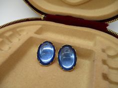 "Vintage Emmons clip on earrings in goldtone featuring a large blue oval cabochon set in scalloped trimmed prongs. 1.25\"x.75\" Some light tarnishing but otherwise in good vintage condition." Luxury Vintage Cabochon Clip-on Earrings, Luxury Clip-on Oval Cabochon Earrings, Star Darlings, Lariat Necklace, Oval Cabochon, Clip On, Cleveland, Chain Link, Etsy Vintage