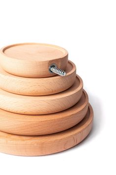 three wooden bowls stacked on top of each other with a screw sticking out of them