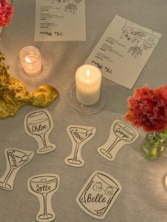 the table is set up with wine glasses and place cards for guests to write their names