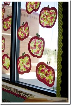 the window is decorated with apples and squares