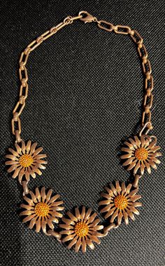 This necklace I believe came from around the 1950s. It’s in excellent condition. It hasn’t got any scratches on It whatsoever. It could be worn with almost anything, especially if you like, vintage jewelry, or a collector Vintage pieces. Vintage Yellow Gold-plated Charm Necklaces, Vintage Charm Yellow Gold Flower Pendant Necklace, Vintage Multicolor Flower Pendant Jewelry, Yellow Flower-shaped Retro Jewelry, Yellow Flower-shaped Jewelry With Sunflower Print, Pretty Little Dress, Yellow Daisy, Daisy Necklace, Rhinestone Bow