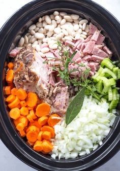 an assortment of vegetables and meat in a slow - cooker bowl, ready to be cooked