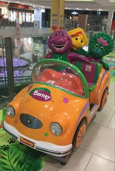 an orange toy car with sesame characters in it