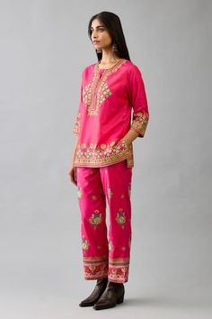 Fuchsia silk short kurta with multicolour cutwork and thread embroidery, embellished by mirrorwork. Comes with pant. - Aza Fashions Spring Bohemian Kurta With Cutwork, Festive Pink Embroidered Pants, Festive Embroidered Pink Pants, Pink Embroidered Festive Pants, Spring Bohemian Cutwork Kurta, Pink Cutwork Straight Kurta, Ankle-length Fitted Kurta With Cutdana, Pink Bohemian Kurta With Cutdana, Silk Shorts