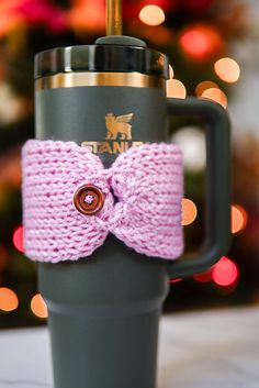 a coffee cup with a knitted bow on it