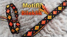 a close up of a braided bracelet on a furry surface with the words motifi biekk written in orange and yellow