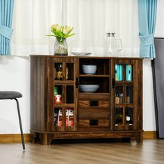 a wooden cabinet sitting in front of a window