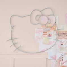 a hello kitty wall hanging on the side of a door