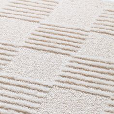 a close up view of a white rug on the floor