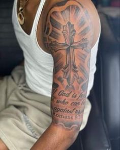 a man with a cross tattoo on his arm