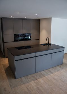 a modern kitchen with an island and sink